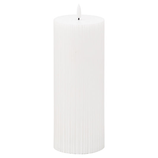 White textured ribbed LED candle featuring a gentle amber flame simulation, designed to enhance ambiance and elegance.