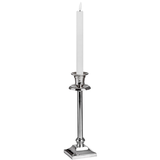 Elegant white LED dinner candle with a realistic wax-like texture, placed in a shiny silver candlestick for a sophisticated ambiance.