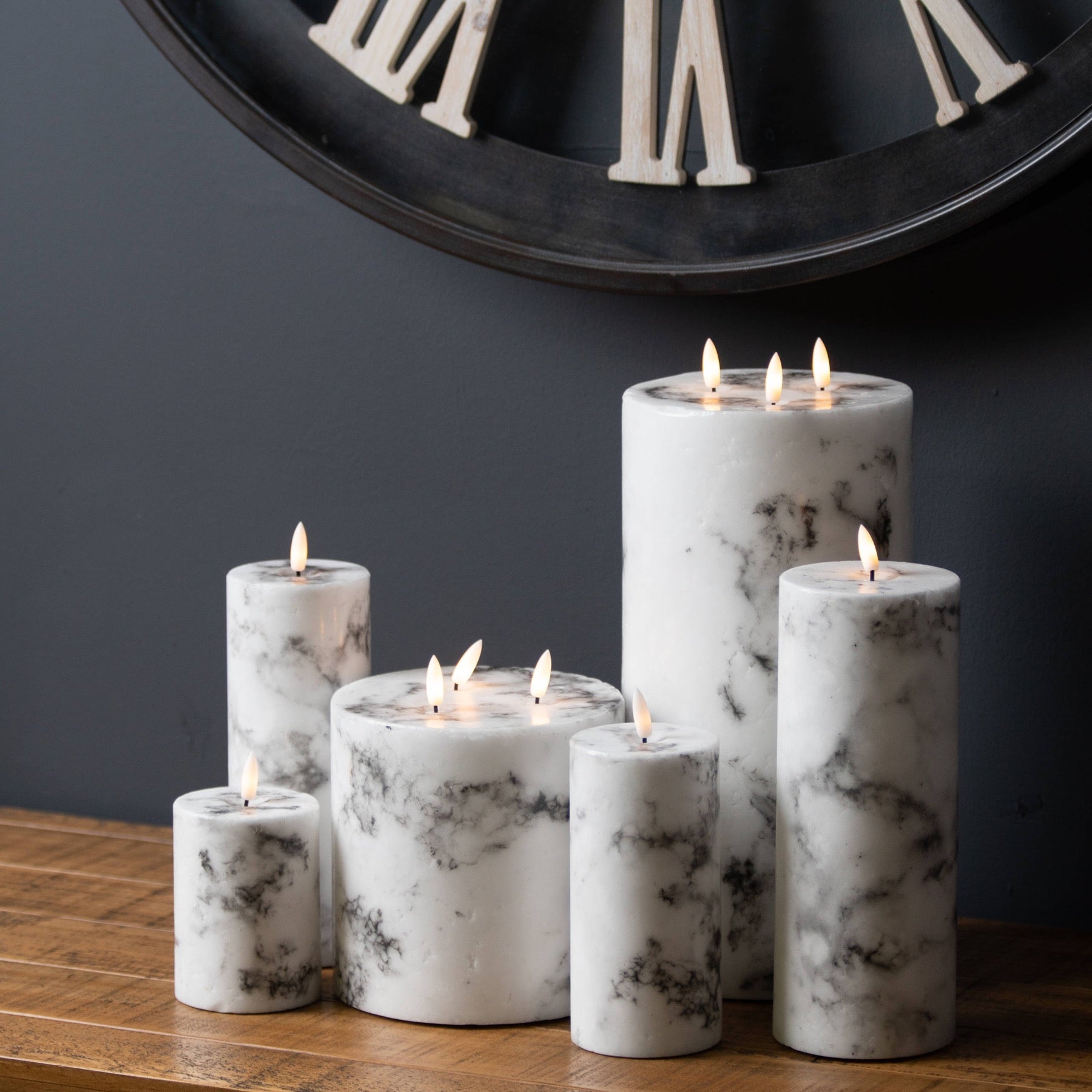 Elegant white LED candles with realistic amber flames, featuring a unique marble-effect design, creating a warm ambiance.