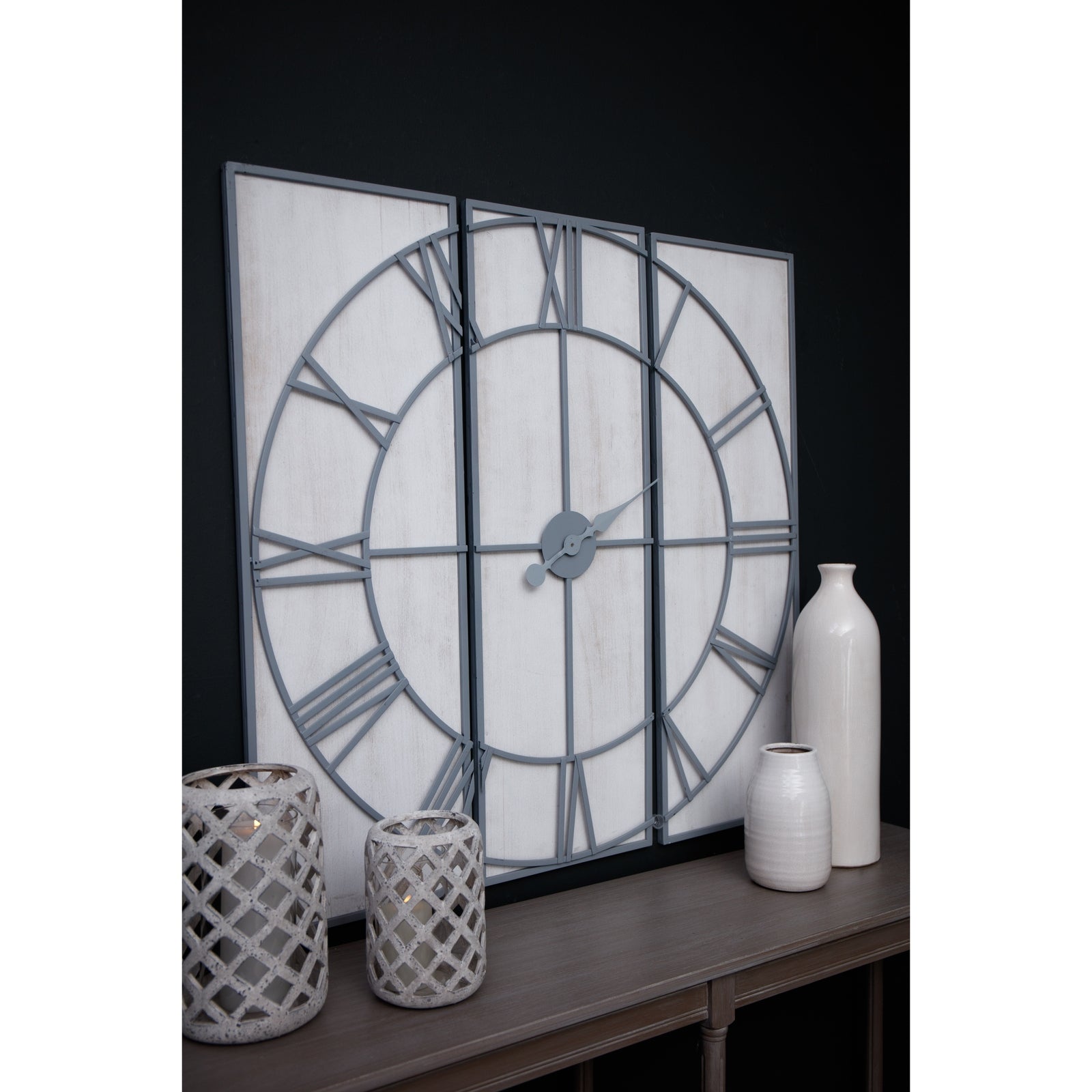 Multi-paneled wall clock features a sleek gray frame with Roman numerals on a white wood background, enhancing any decor.