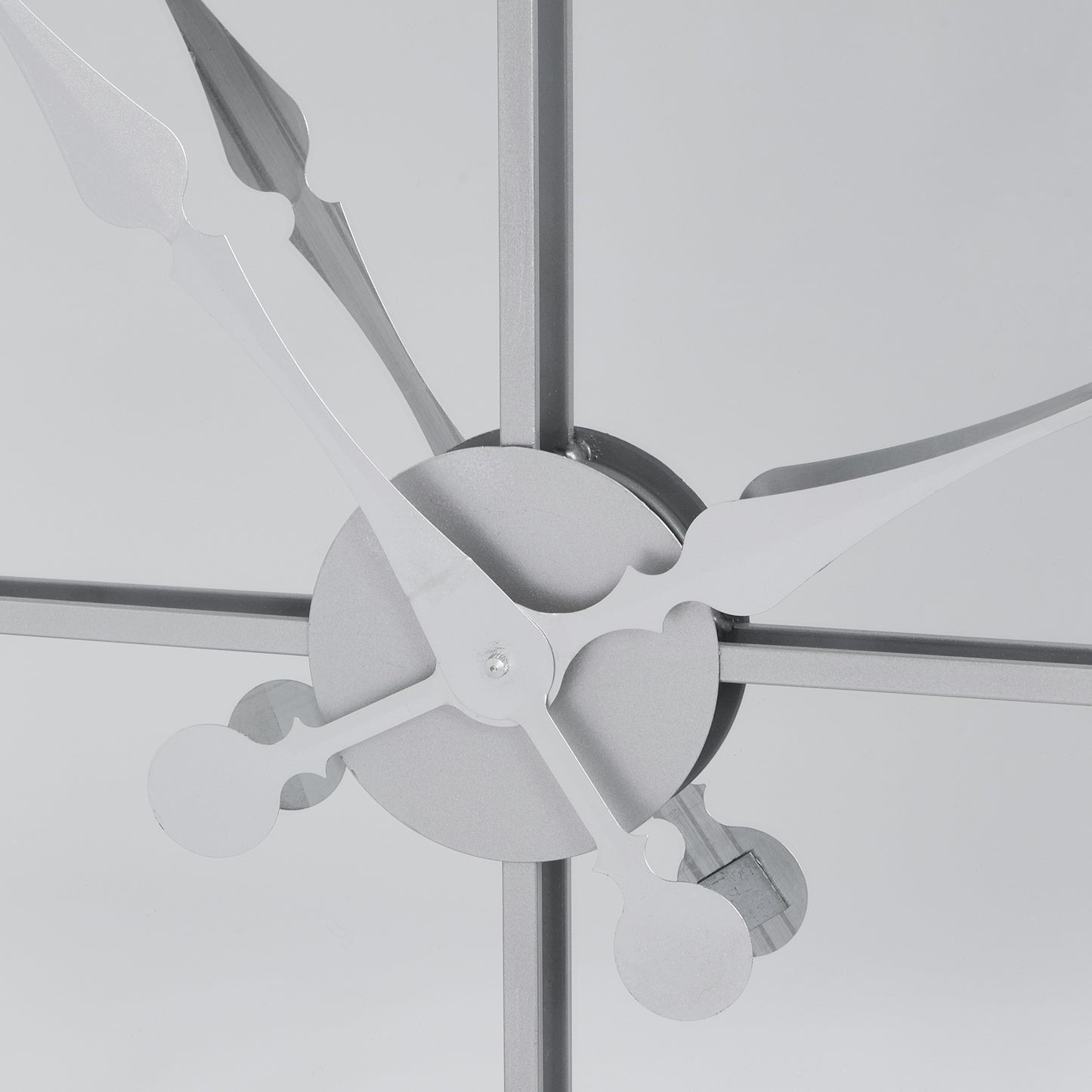 Sophisticated silver wall clock with a mirrored finish and unique three-panel design featuring sleek metalwork over glass.