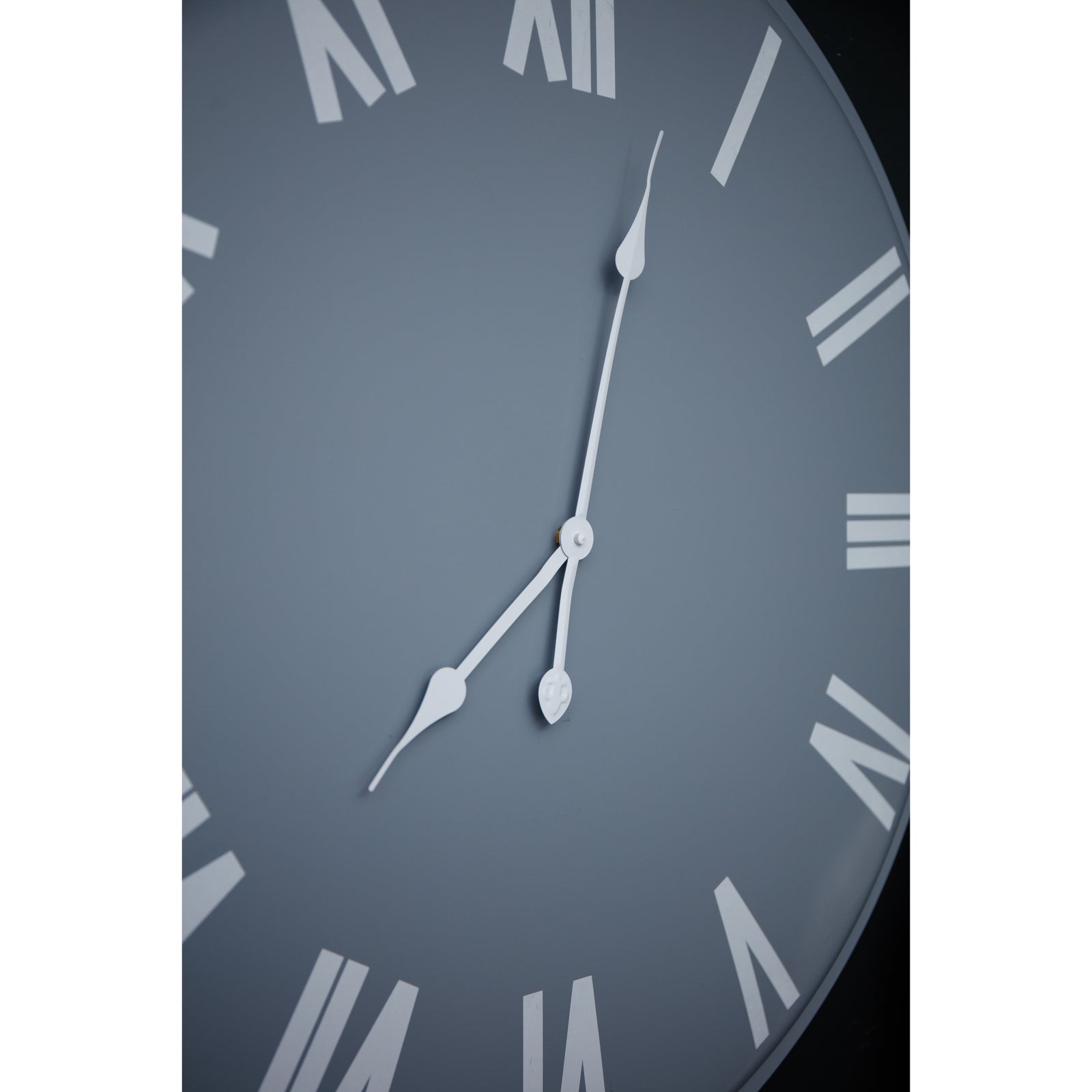 Large wall clock featuring a sleek light grey face with bold white Roman numerals and hands, measuring 80cm in diameter.