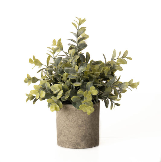 Artificial eucalyptus plant with silvery-green leaves in an elegant stone-effect pot, adding a touch of tranquility to any decor.
