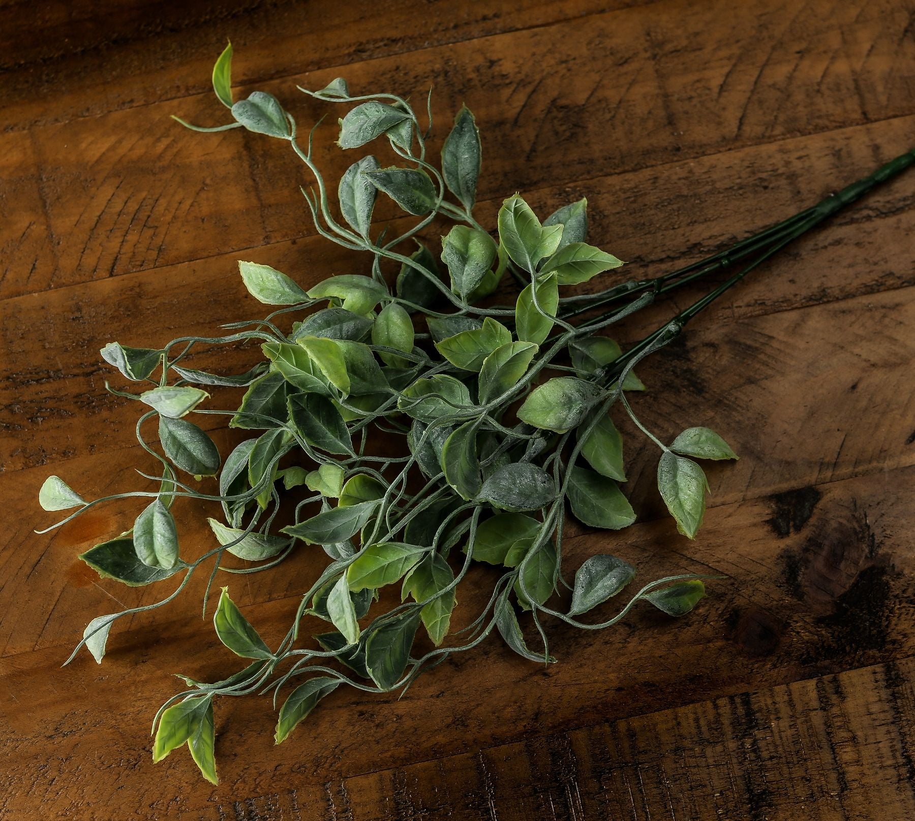 Lifelike green foliage bunch with varied shades, featuring realistic leaves and natural movement, perfect for any decor style.