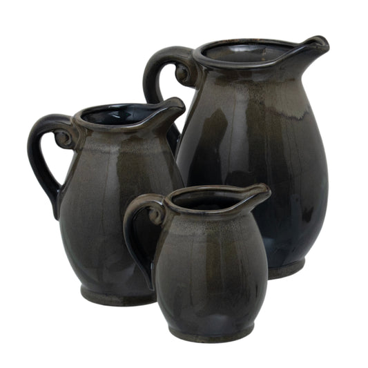 Sophisticated ceramic vase set featuring a unique reactive glaze, blending deep charcoal to olive tones, showcasing elegant curves.