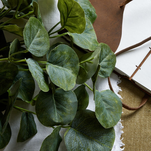 Lush, lifelike green eucalyptus leaves arranged in a compact bunch, perfect for small vases or table displays.