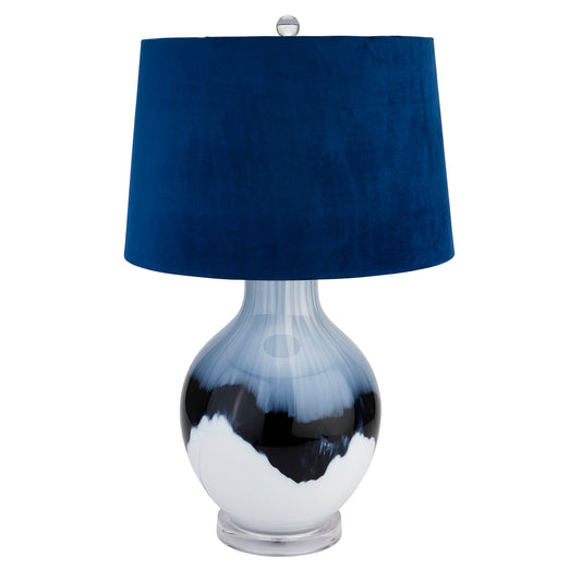 Handcrafted table lamp with a unique blue and white glazed base, topped with a rich navy velvet shade, providing elegant ambiance.