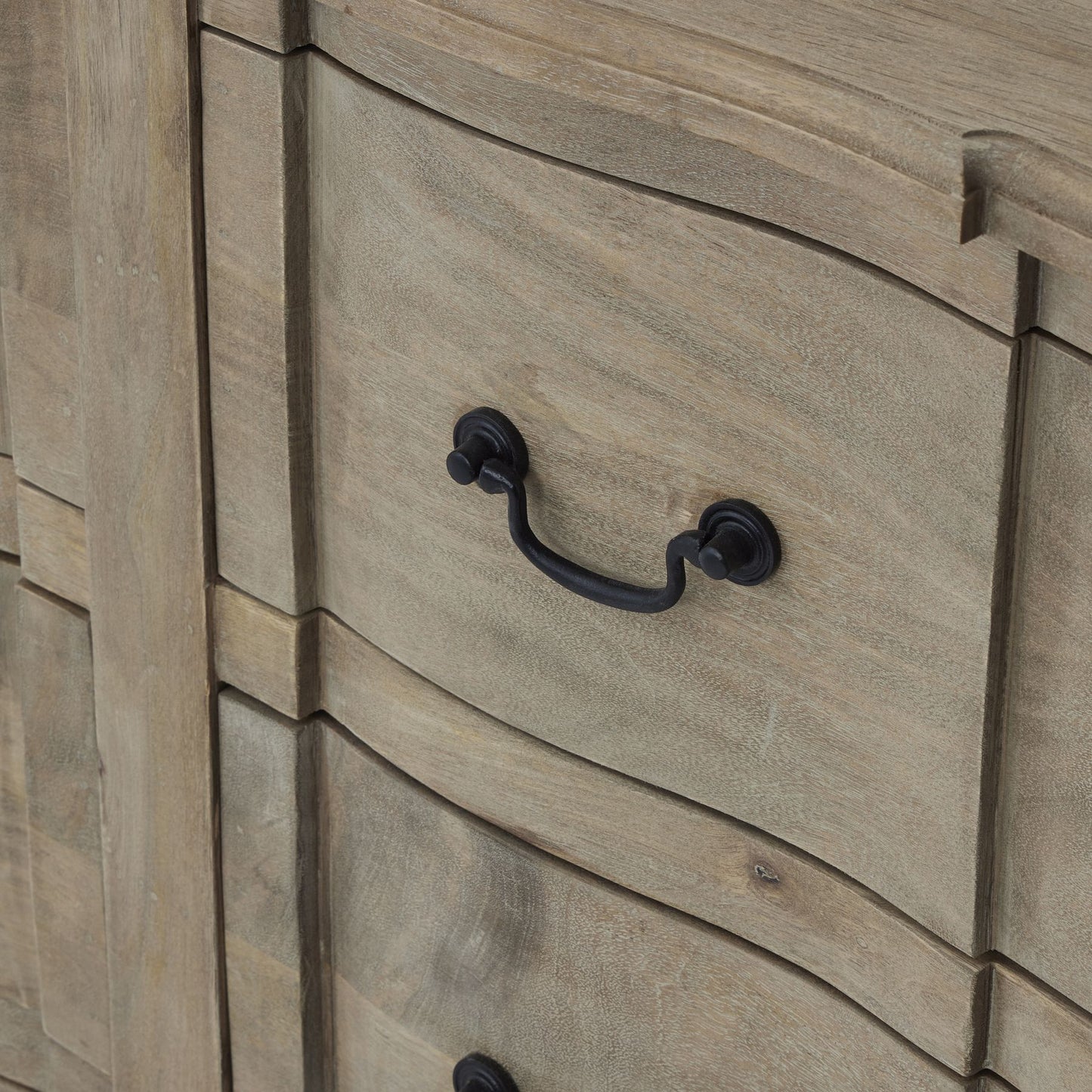 Washed wood 6-drawer chest with curved edges and black iron handles, blending French provincial and modern styles.