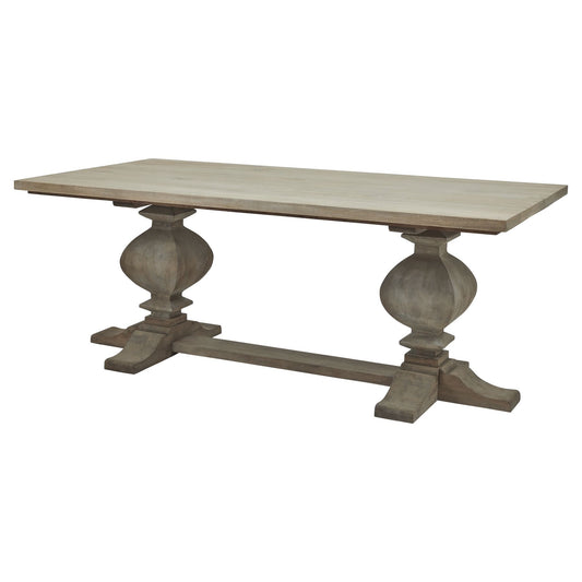Large dining table in washed, bleached hardwood with black iron accents; features elegant, sculptural legs inspired by French design.