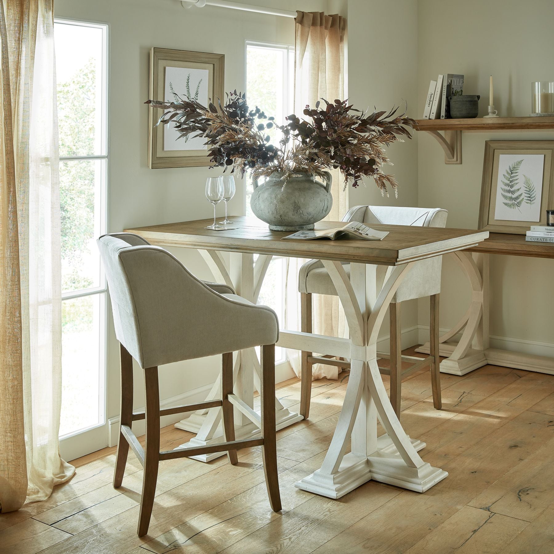 Taupe and ivory large branch arrangement in a minimalist vase atop a wooden table, enhancing an elegant, serene interior.