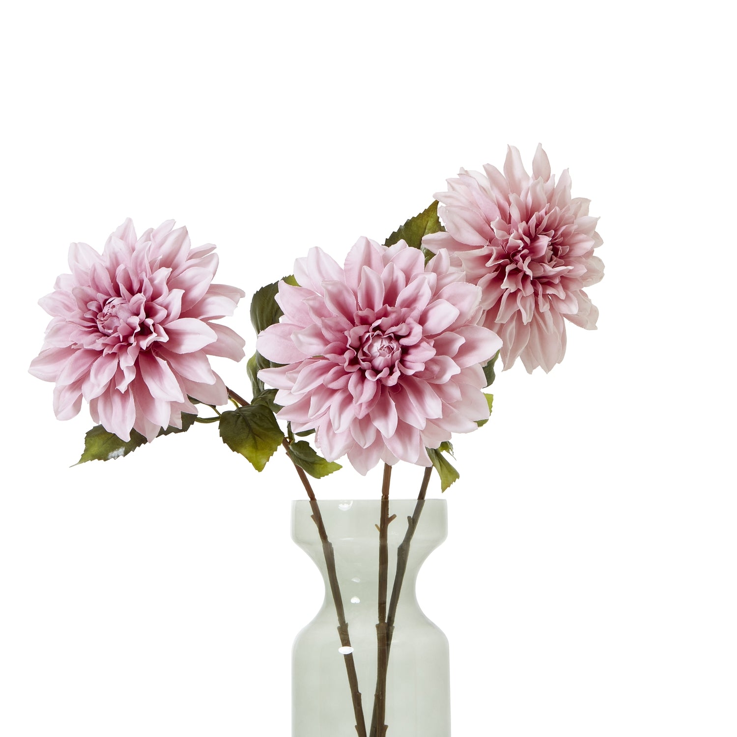 Three lifelike pink dahlias in a clear vase, showcasing soft petals and lush green leaves, adding elegance to any decor.