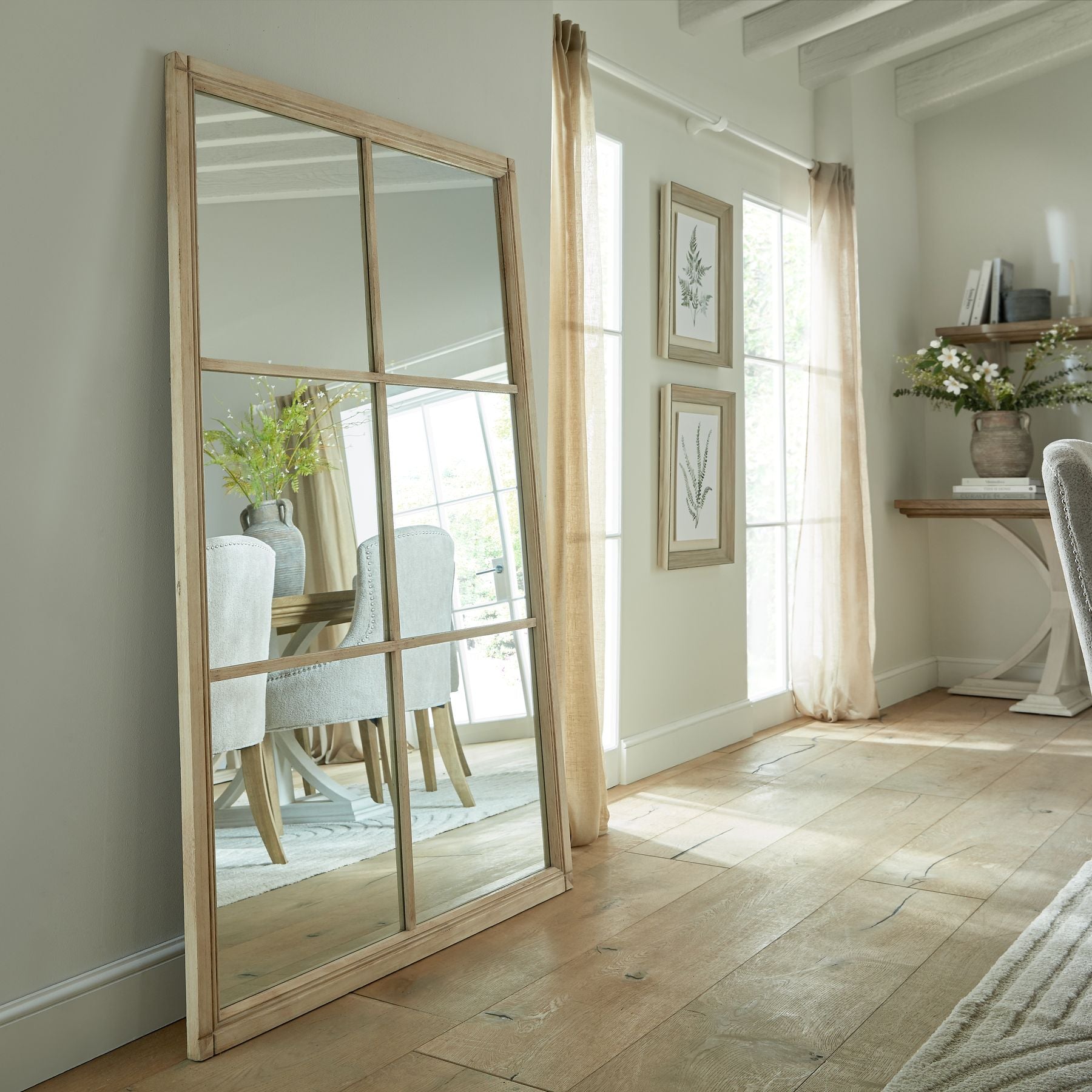 Rustic XL window mirror with a weathered wood frame, showcasing a distressed finish for vintage charm in a bright interior.