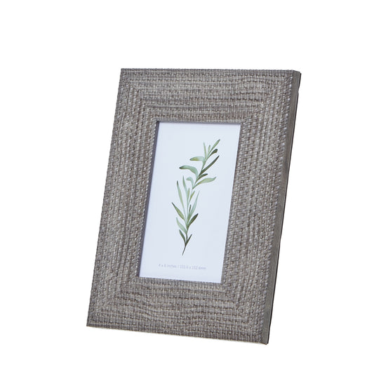 Grey-washed woven photo frame for 4x6 photos, featuring an intricate weave pattern, ideal for elegant decor arrangements.
