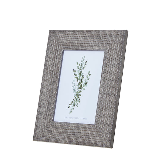 Textured grey-washed woven photo frame in a 5x7 size, showcasing a delicate botanical print. Perfect for stylish decor.
