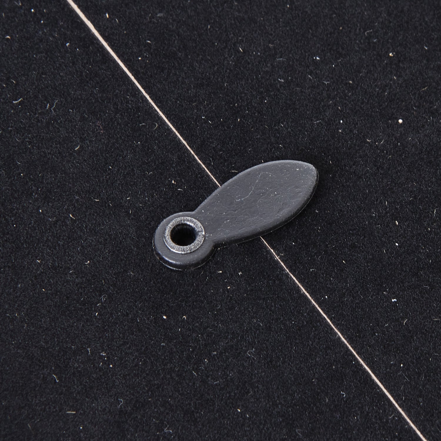 Close-up of a black backing with a circular hole for hanging, showcasing craftsmanship elements of the Woven Photo Frame.