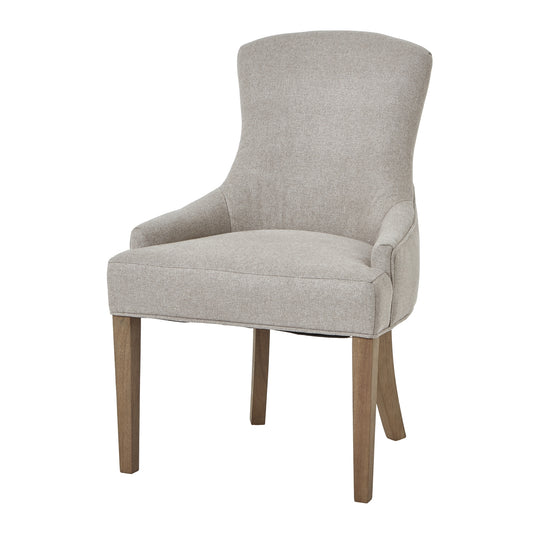 Plush oatmeal twill dining chair with elegant tufted detailing and sturdy oak legs, designed for refined comfort and style.