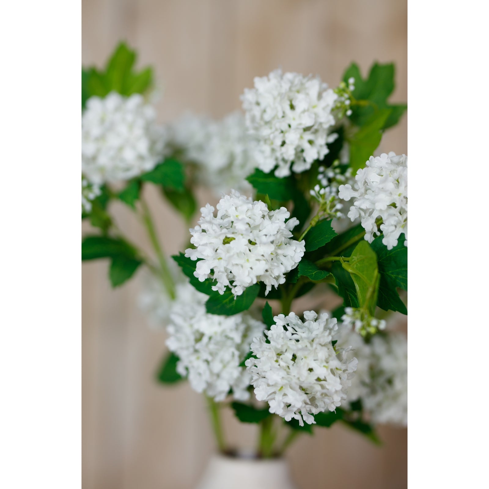 Lifelike cream snowball viburnum spray with spherical white blooms and lush green foliage, perfect for elegant home decor.