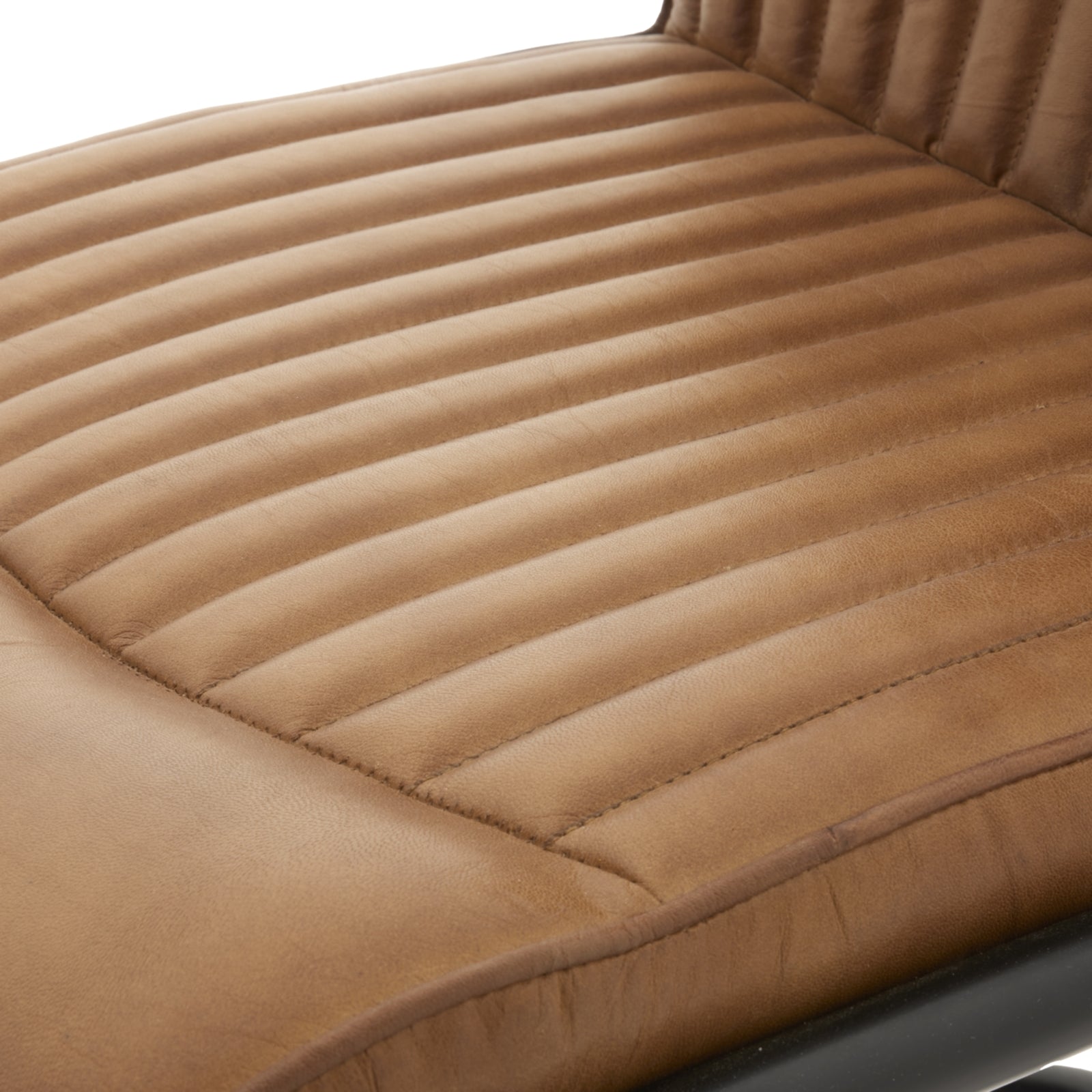 Caramel leather dining chair with vertical ribbed upholstery and a sleek black metal frame, blending industrial charm and modern elegance.