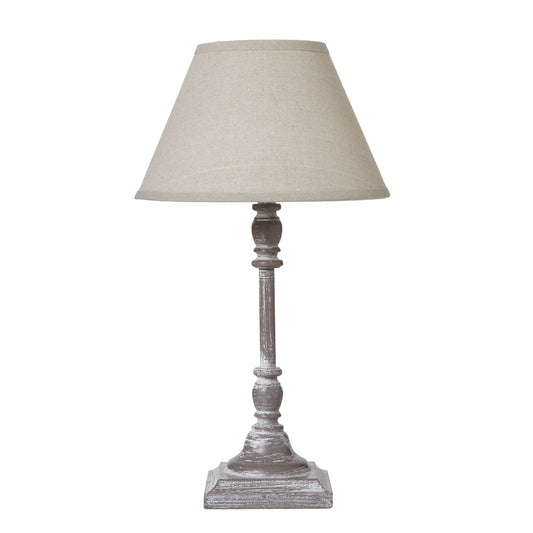Elegant table lamp with a textured gray stem and a soft linen shade, adding a cozy touch to modern interiors.