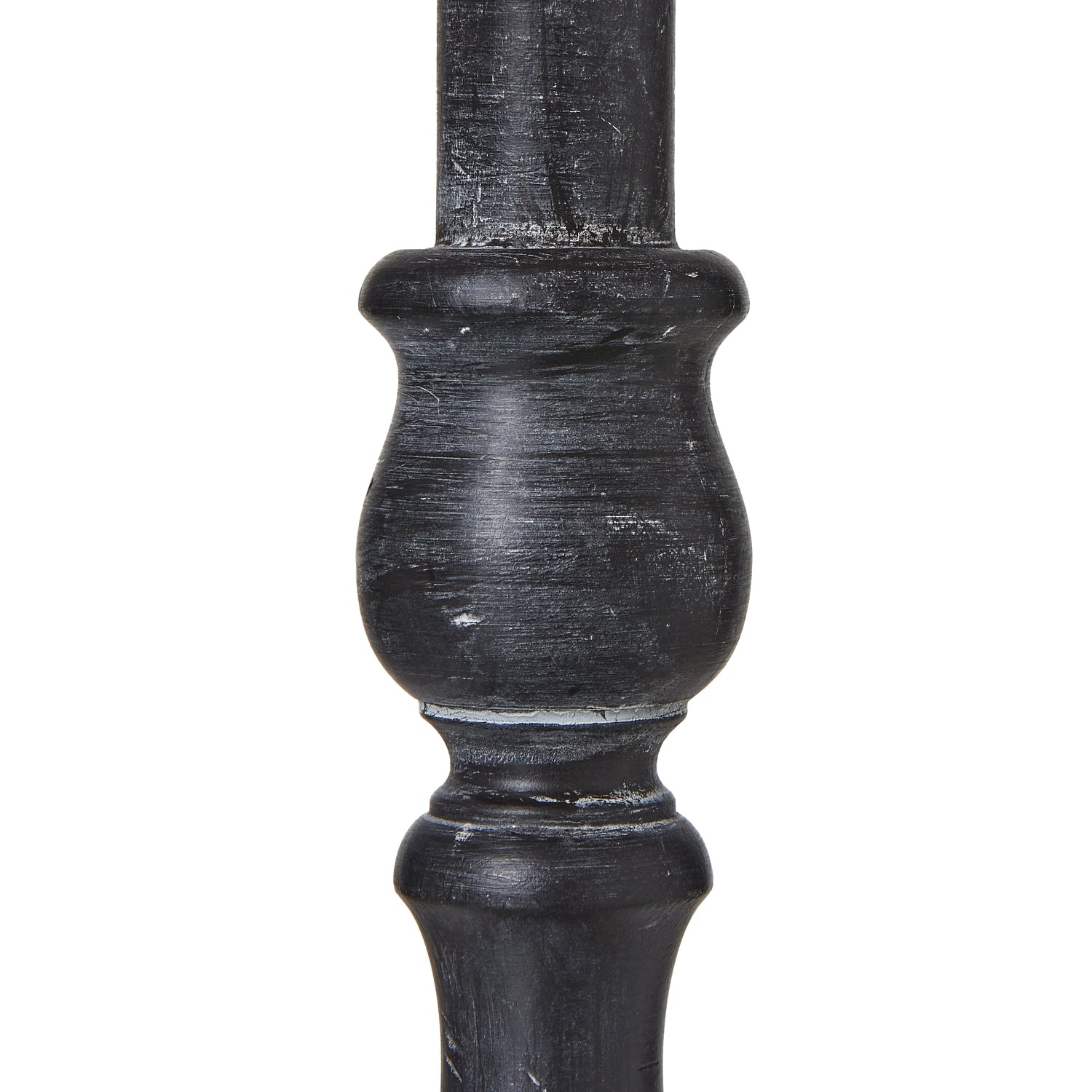 Distressed black base with intricate contours supports a neutral linen shade, enhancing modern or farmhouse interiors.