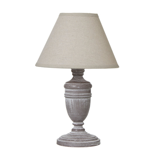 Urn-shaped table lamp with a distressed gray base and a neutral linen shade, perfect for adding rustic elegance to any room.