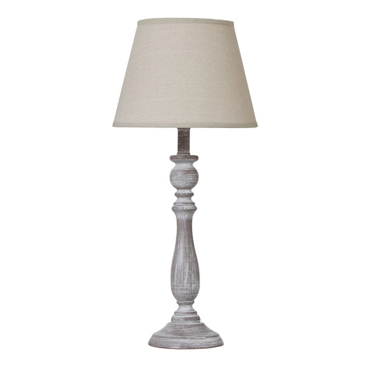Elegant table lamp with a rustic-white carved column base and soft beige linen shade, perfect for any sophisticated space.