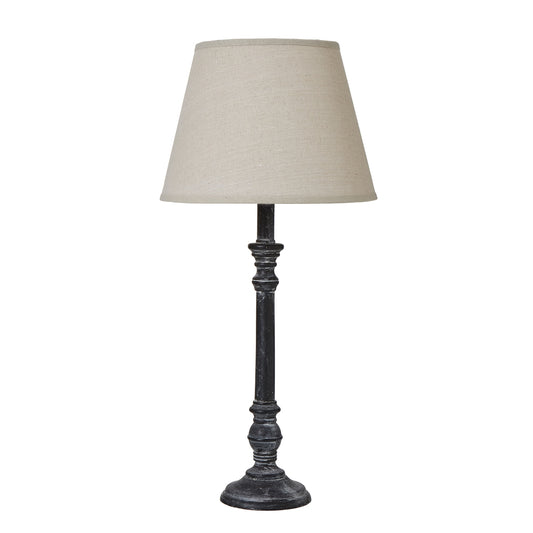 Elegant table lamp with a black stem and intricate detailing, topped by a soft beige linen shade, perfect for any decor.