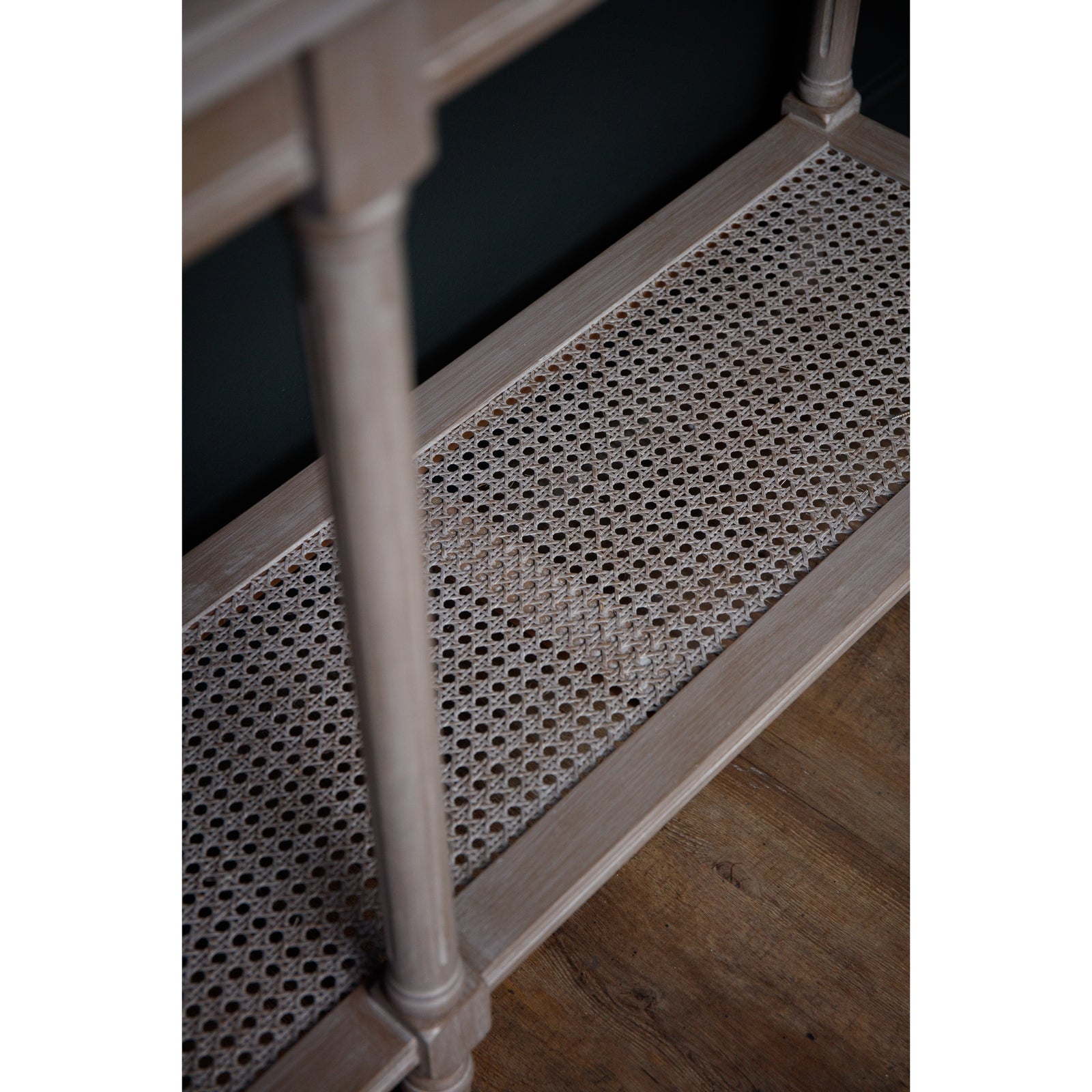 Large console table featuring intricate rattan weave and sleek, tapered legs in a warm, natural finish, perfect for modern interiors.