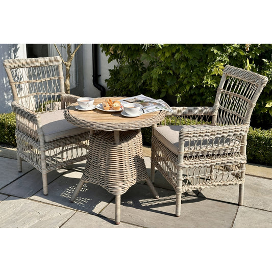Elegant outdoor bistro table with a warm wood top, surrounded by stylish woven chairs, ideal for intimate gatherings.