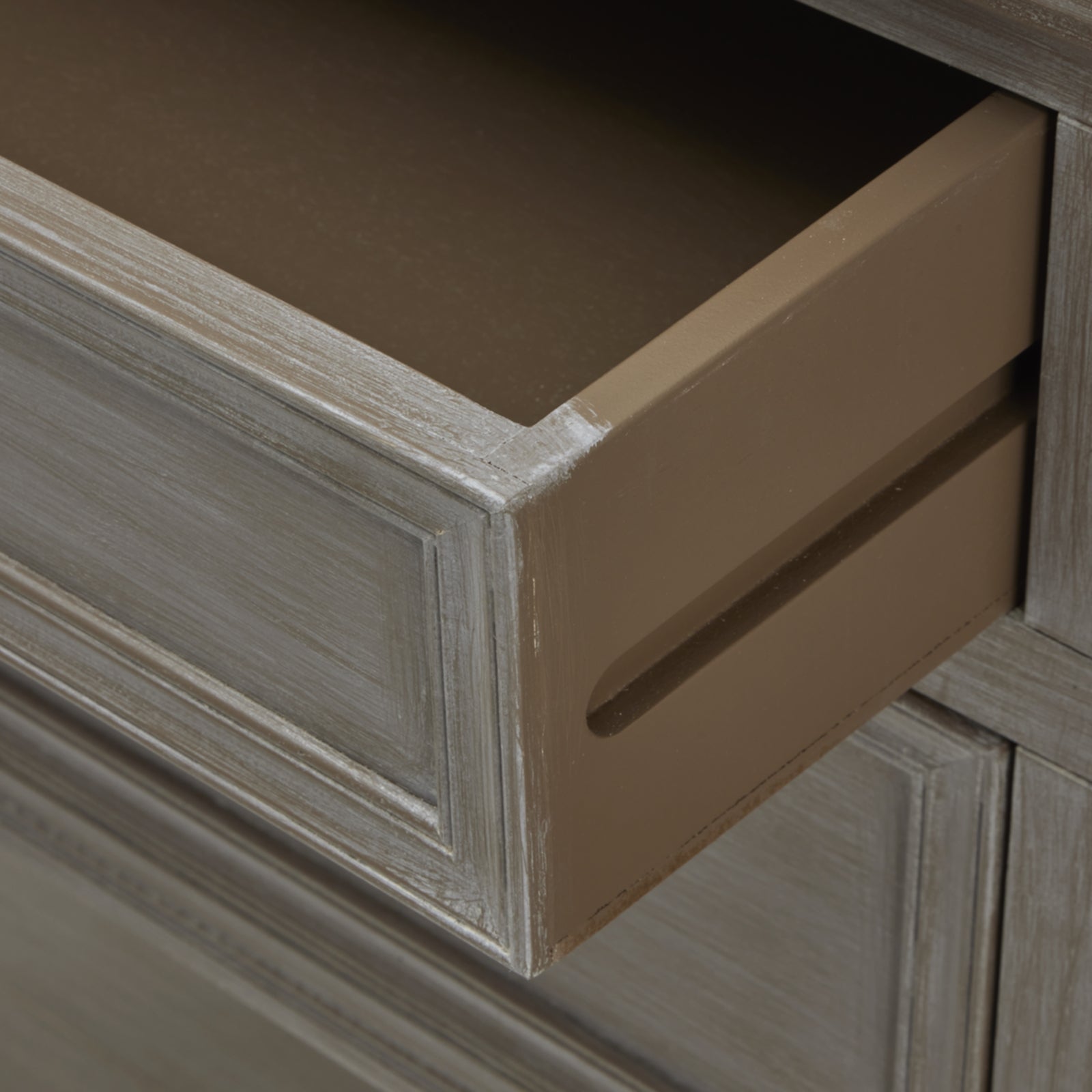 Close-up of a console table drawer with a delicate beige finish, showcasing refined craftsmanship and elegant design details.
