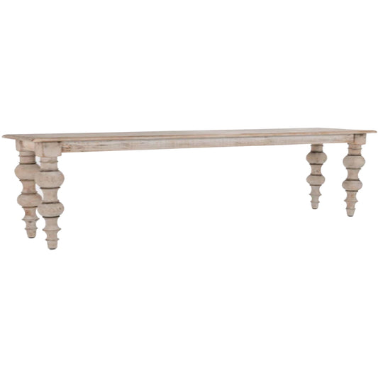 Rectangular bench with a weathered finish and elegantly turned legs, showcasing minimalist design and British craftsmanship.