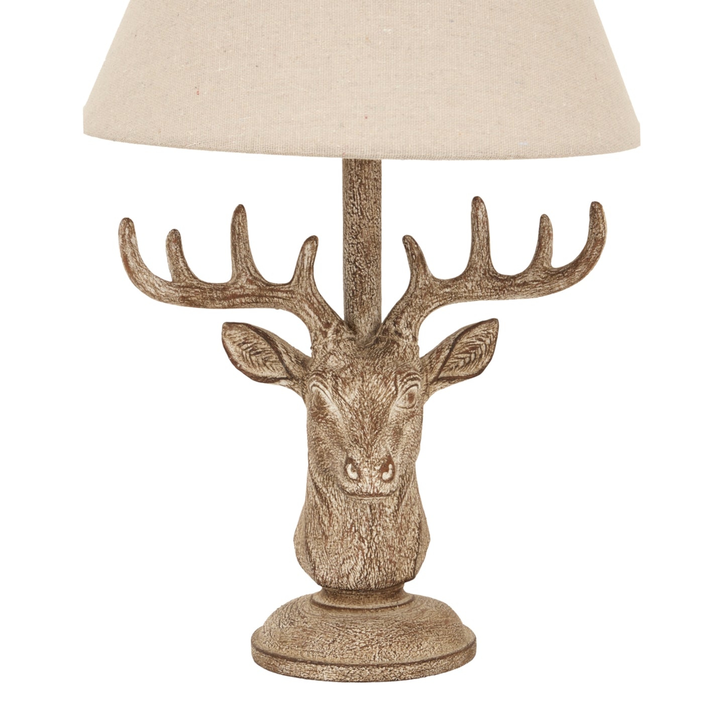 Stonewashed stag head table lamp features detailed craftsmanship and a chic linen shade, blending rustic and modern styles.