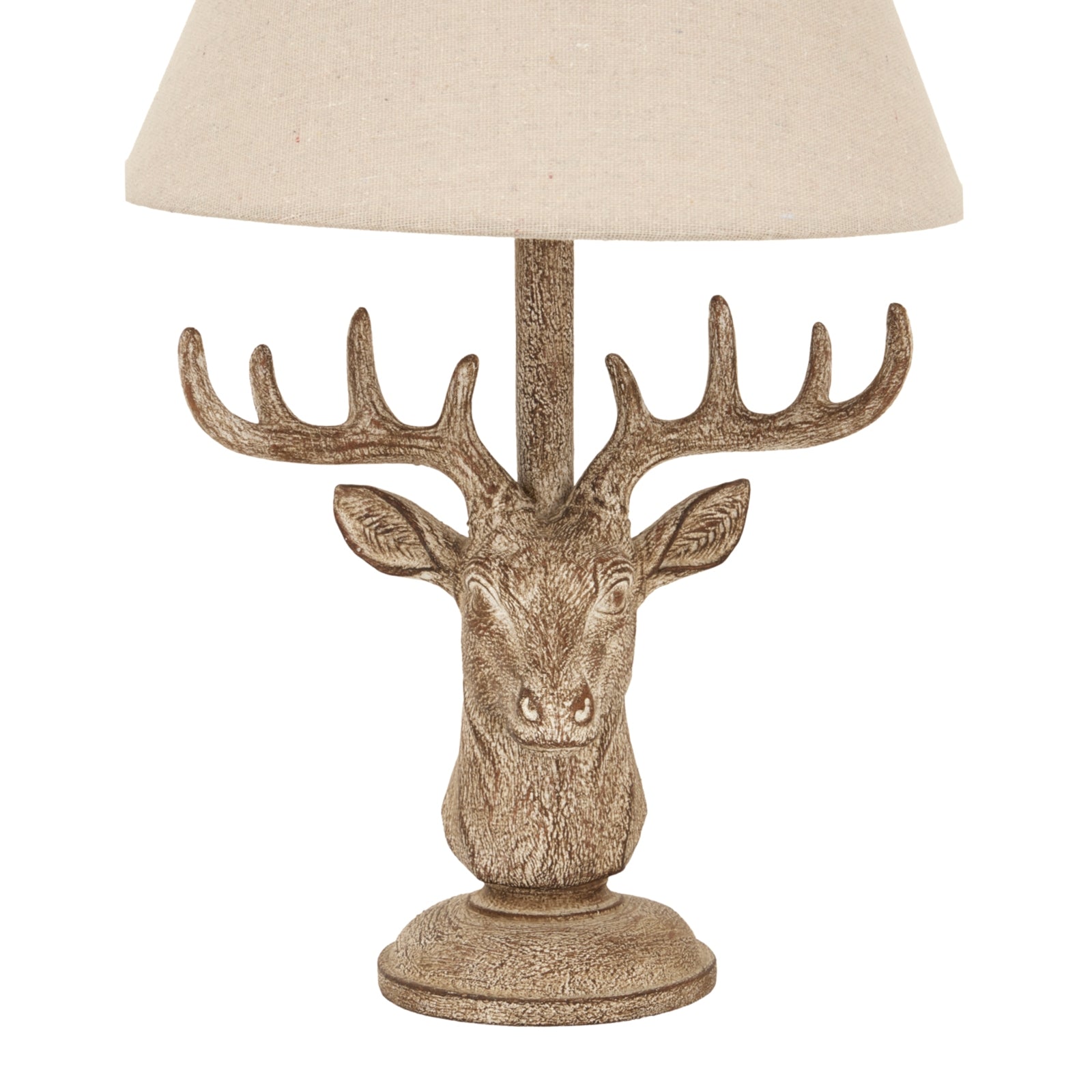 Stonewashed stag head table lamp features detailed craftsmanship and a chic linen shade, blending rustic and modern styles.