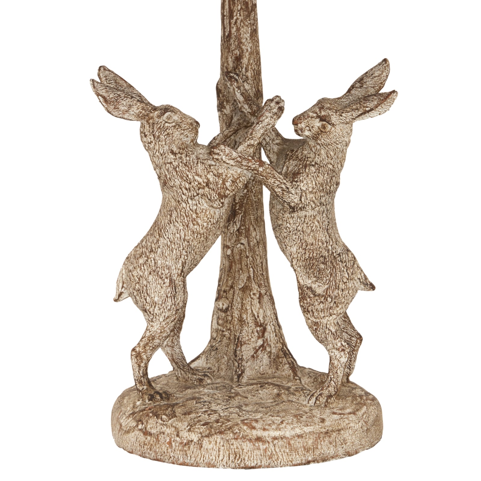 Stonewashed lamp features two detailed hares playfully poised on a textured base, topped with a natural linen shade for warm ambiance.