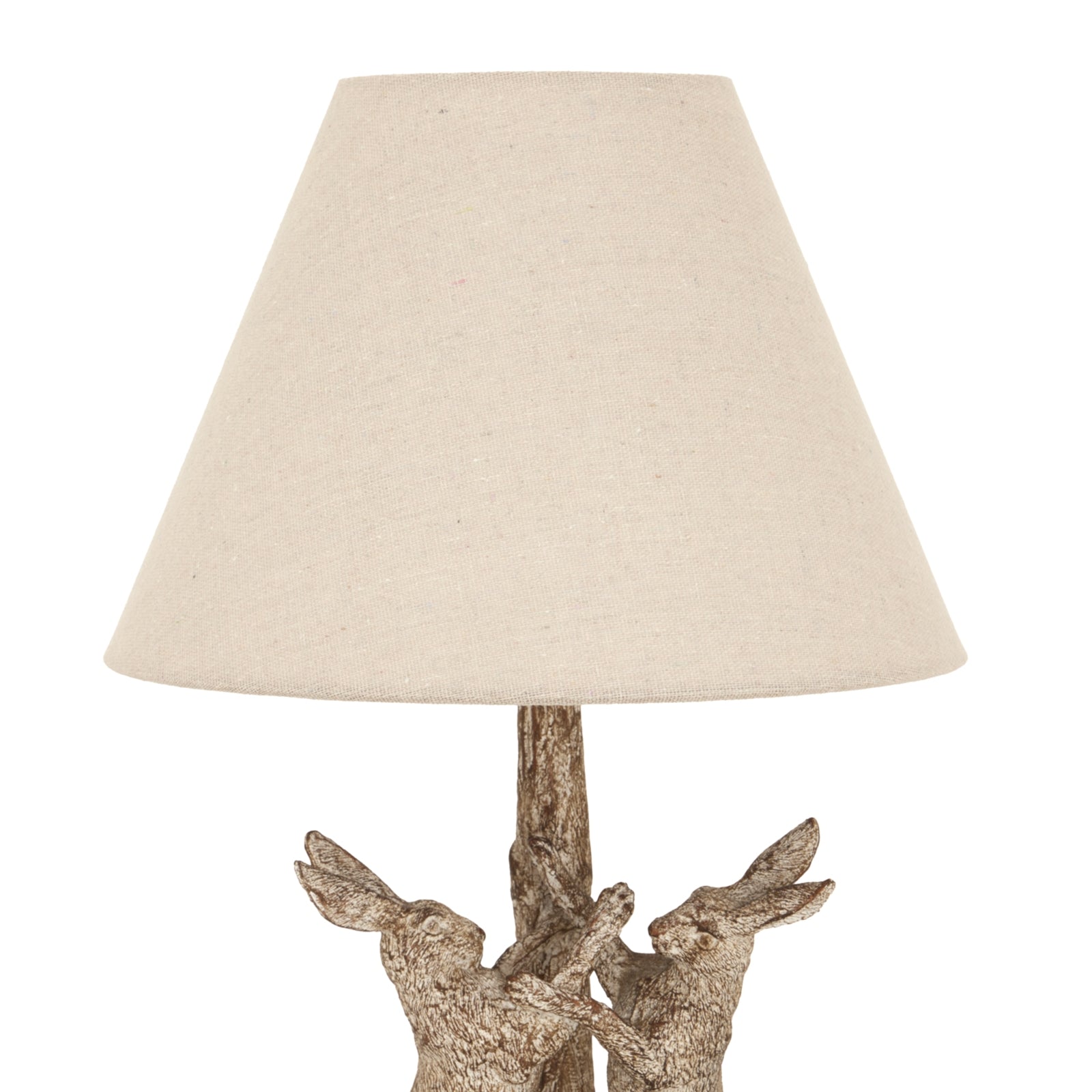 Stonewashed lamp featuring intricately detailed marching hares in neutral tones, topped with a soft linen shade for warm illumination.