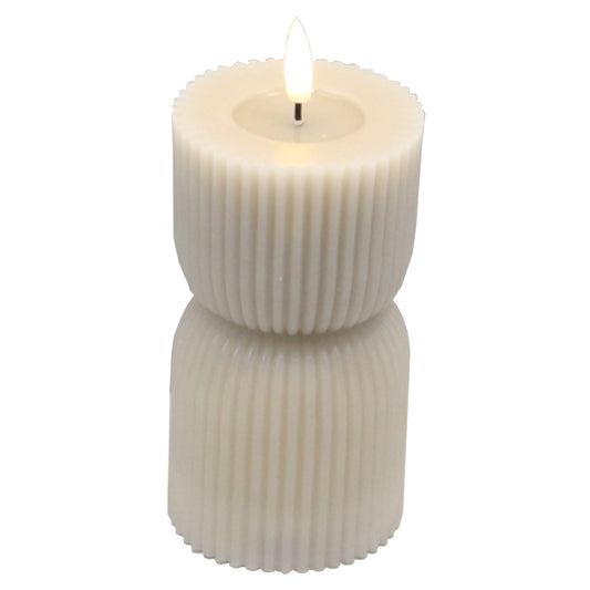 Stone-carved LED candle in a soft ivory color, featuring a flickering flame effect and elegant ribbed design, measuring 2.75x6 inches.