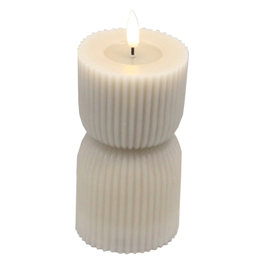 Stone-carved LED candle featuring a ribbed design in soft ivory, giving a warm, soothing glow for elegant home decor.