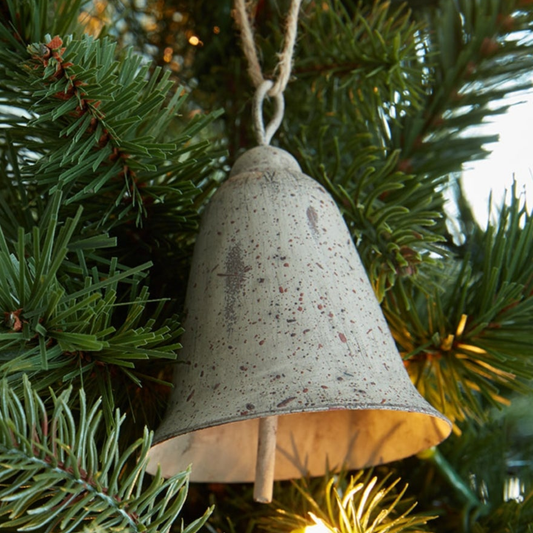 Large rustic metal hanging bell on a Christmas tree